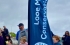 Children sitting beside Looe Marine Conservation Group sailflag